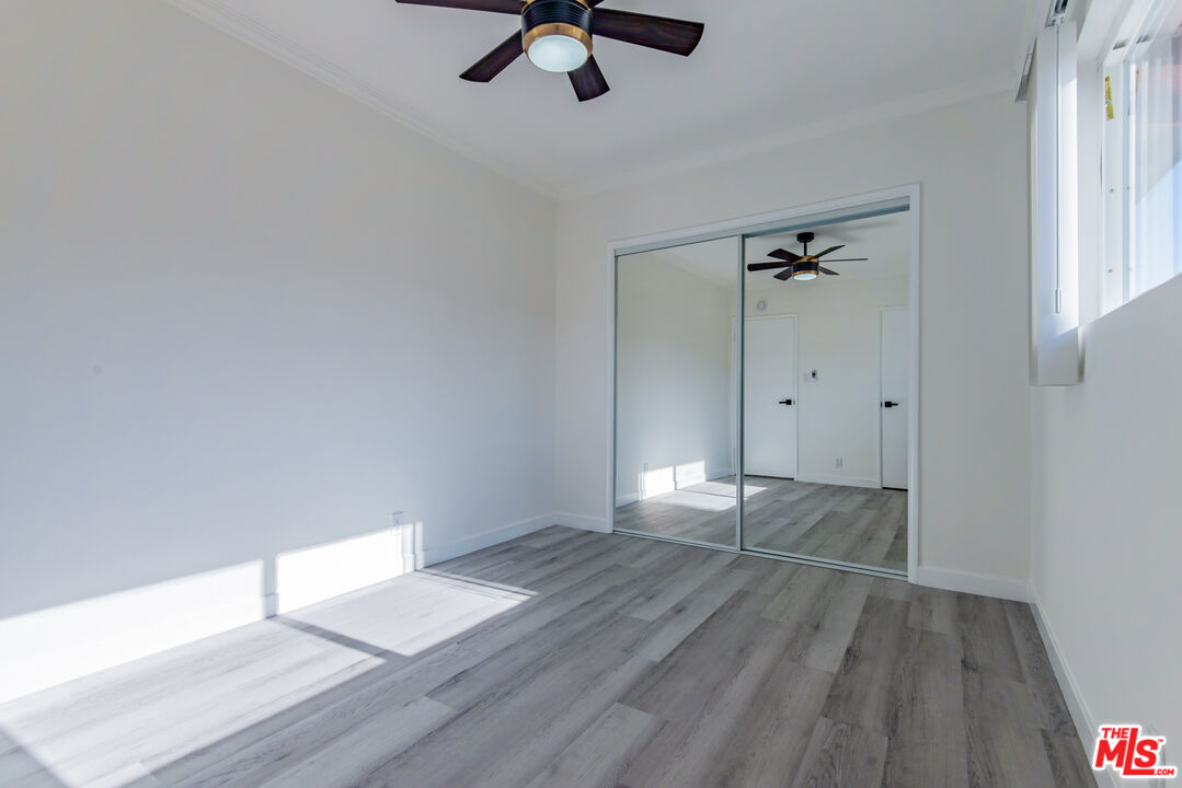 2107 Pullman Lane, Unit D Redondo Beach, CA 90278 - Photo 30 of 32 an empty room with wooden floor cabinet and windows