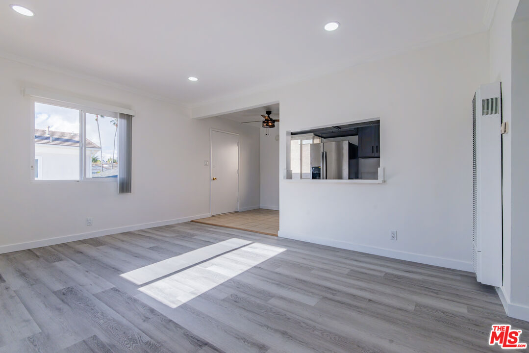 2107 Pullman Lane, Unit D Redondo Beach, CA 90278 - Photo 3 of 32 an empty room with wooden floor and windows