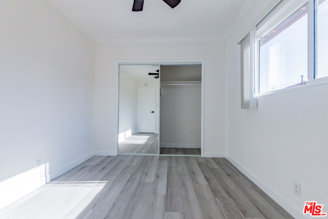 2107 Pullman Lane, Unit D Redondo Beach, CA 90278 - Photo 32 of 32 a view of empty room with wooden floor and fan