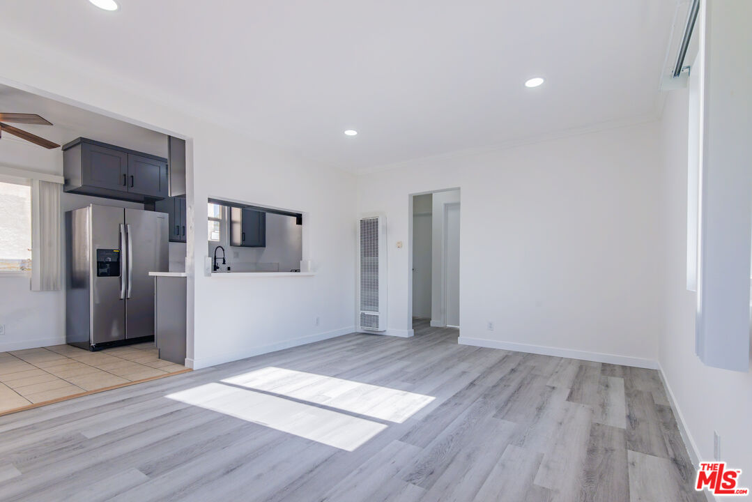 2107 Pullman Lane, Unit D Redondo Beach, CA 90278 - Photo 4 of 32 a view of a kitchen with wooden floor and a refrigerator