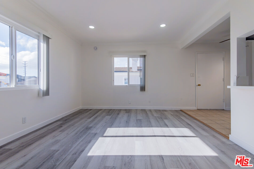 2107 Pullman Lane, Unit D Redondo Beach, CA 90278 - Photo 5 of 32 a view of an empty room with wooden floor and a window