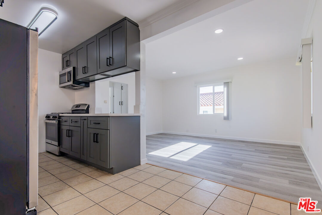 2107 Pullman Lane, Unit D Redondo Beach, CA 90278 - Photo 6 of 32 a kitchen with stainless steel appliances granite countertop a stove and a refrigerator