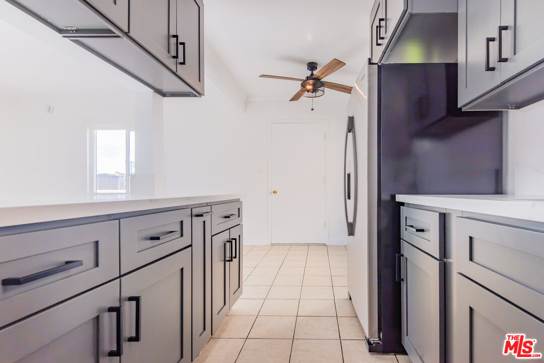 2107 Pullman Lane, Unit D Redondo Beach, CA 90278 - Photo 7 of 32 a kitchen with cabinets and a refrigerator