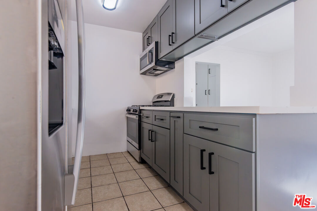 2107 Pullman Lane, Unit D Redondo Beach, CA 90278 - Photo 8 of 32 a kitchen with stainless steel appliances a stove and a refrigerator