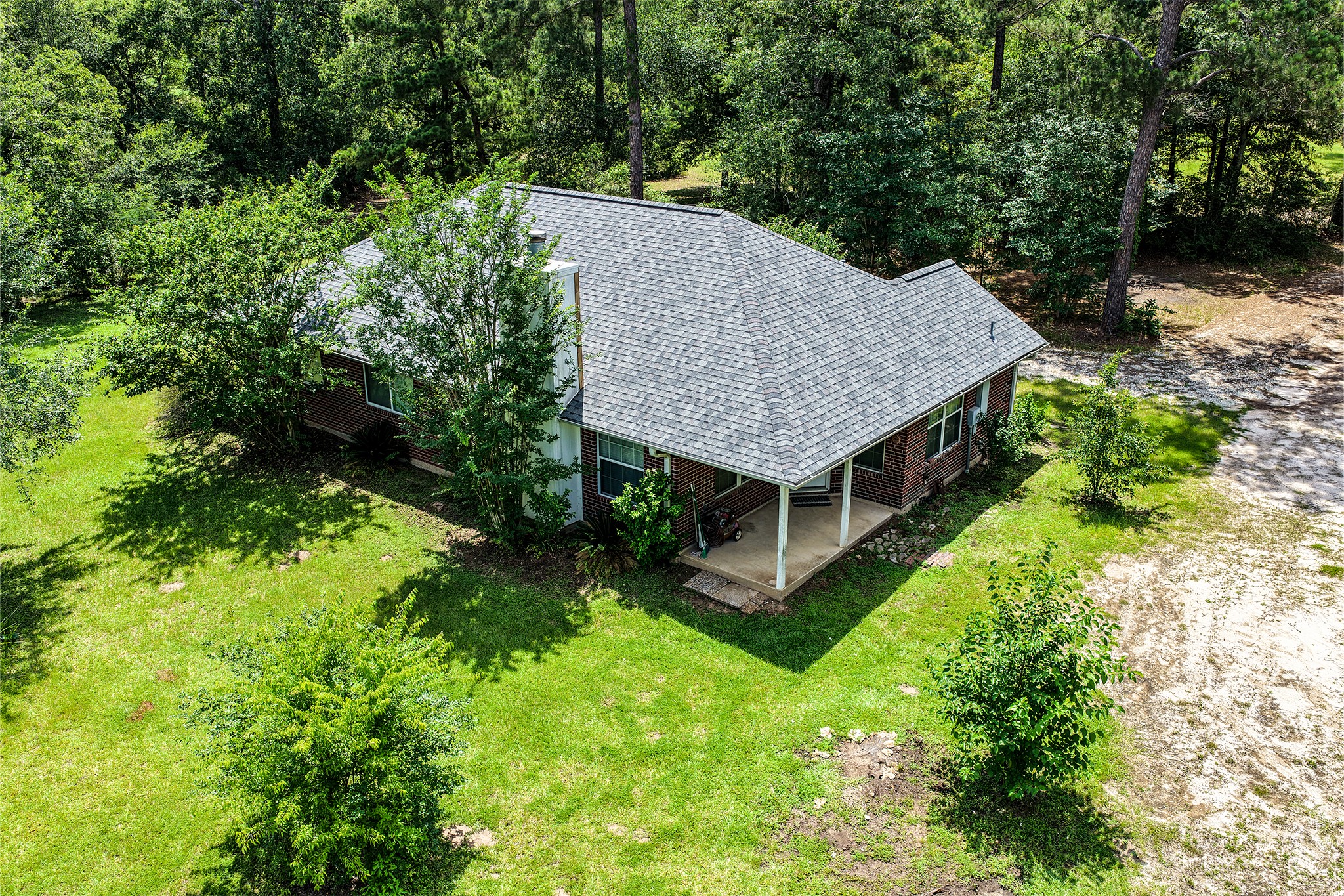691 Bishop Road Huntsville, TX 77320 - Photo 24 of 32 an aerial view of a house with a yard table and chairs