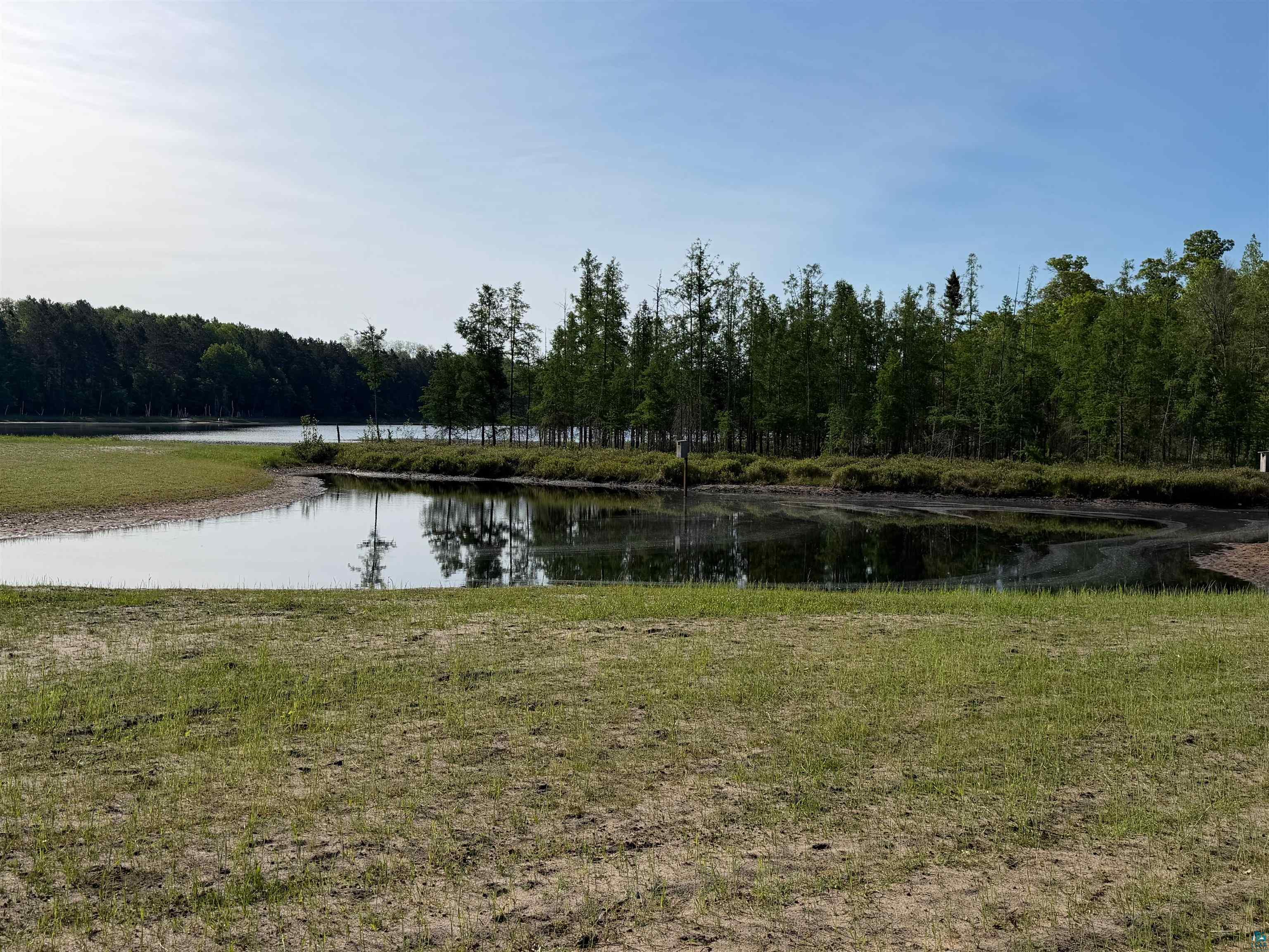 11702 East Mail Road Gordon, WI 54838 - Photo 26 of 60 Expansive water frontage with mature trees and natural landscaping