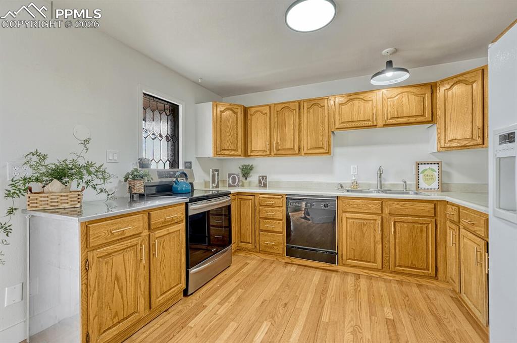 7815 Maverick Road Colorado Springs, CO 80908 - Photo 17 of 41 kitchen with leaded glass window, lots of light