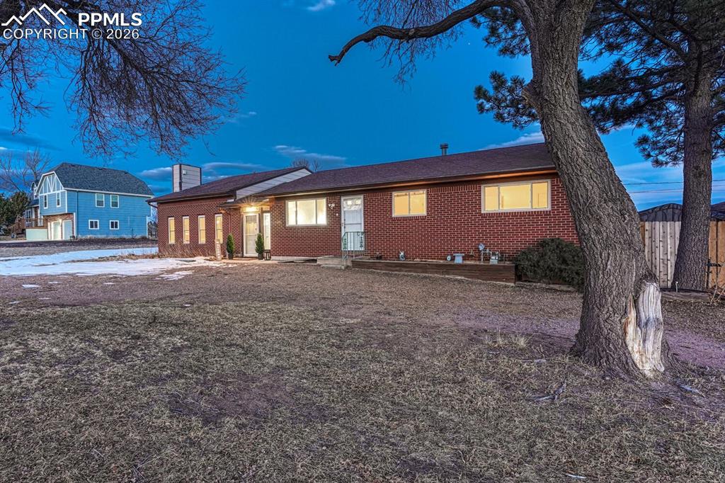 7815 Maverick Road Colorado Springs, CO 80908 - Photo 2 of 41 Brick fronted home with lots of west facing windows and sweeping front ranch views.