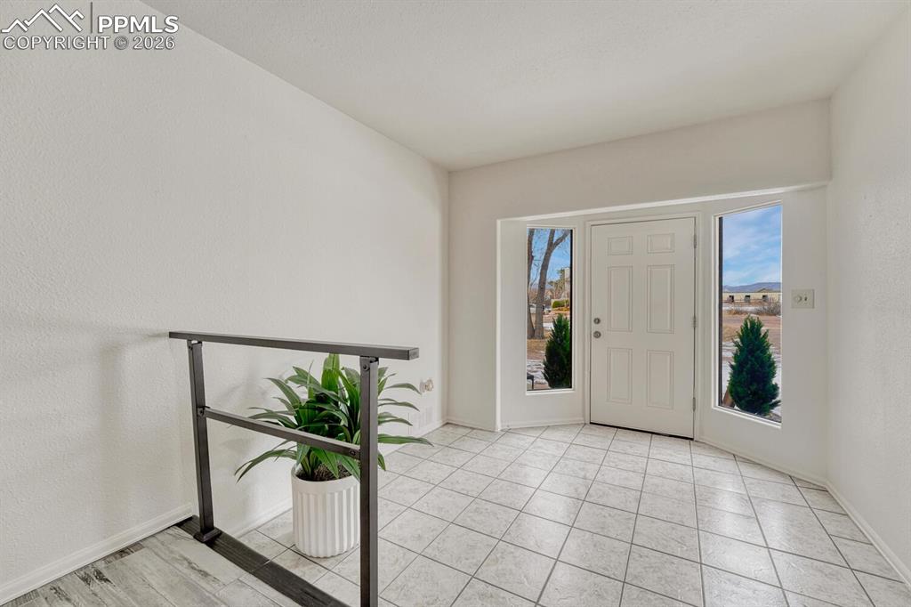 7815 Maverick Road Colorado Springs, CO 80908 - Photo 3 of 41 One of the 2 front entrances, with a large tile foyer and window panels for more light.