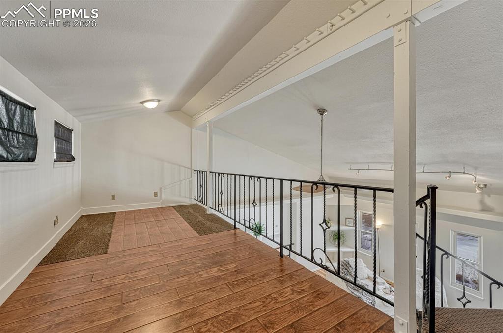 7815 Maverick Road Colorado Springs, CO 80908 - Photo 10 of 41 loft above living room. Game zone, library, office, craft corner? Tons of possibilities!