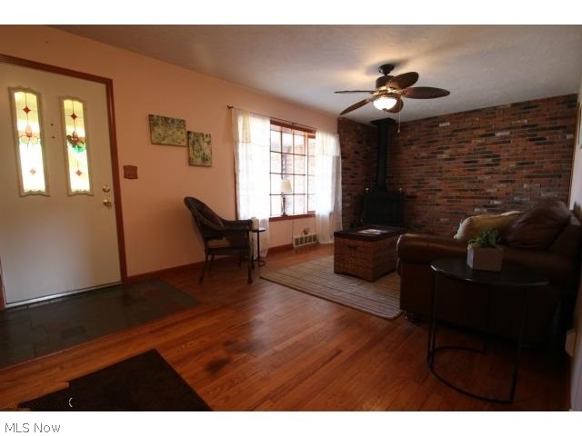 5 Prentice Road Painesville, OH 44077 - Photo 5 of 16 THE ATTRACTIVE BRICK ACCENT WALL FEATURES A WOOD BURNING STOVE THAT ADDS A COZY TOUCH TO THE LIVING ROOM.