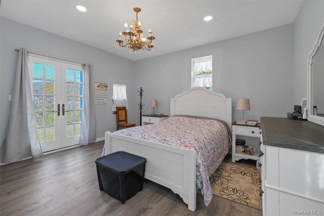 241 Smith Clove Road Highland Mills, NY 10930 - Photo 4 of 26 a bedroom with a bed and a chandelier