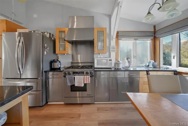 a kitchen with granite countertop a refrigerator and a stove