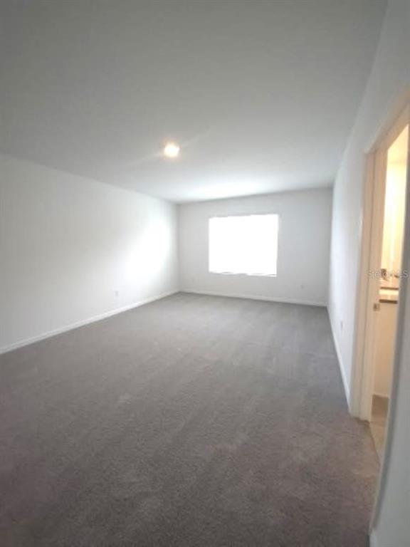 35589 Lockman Way Zephyrhills, FL 33541 - Photo 18 of 54 an empty room with windows