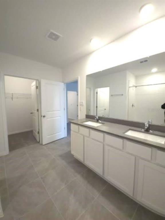 35589 Lockman Way Zephyrhills, FL 33541 - Photo 20 of 54 a large bathroom with a double vanity sink and a mirror