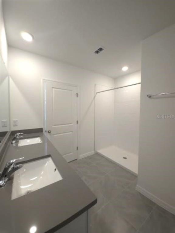 35589 Lockman Way Zephyrhills, FL 33541 - Photo 24 of 54 a bathroom with a sink and a shower