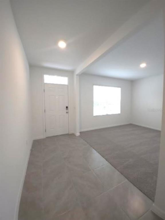 35589 Lockman Way Zephyrhills, FL 33541 - Photo 3 of 54 an empty room with windows