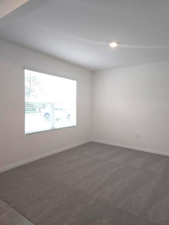 35589 Lockman Way Zephyrhills, FL 33541 - Photo 4 of 54 an empty room with a window