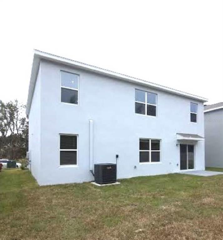 35589 Lockman Way Zephyrhills, FL 33541 - Photo 47 of 54 a view of a house with backyard