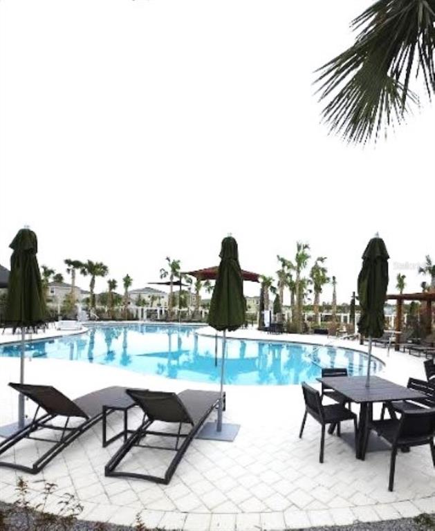 35589 Lockman Way Zephyrhills, FL 33541 - Photo 52 of 54 a view of a lake and outdoor seating