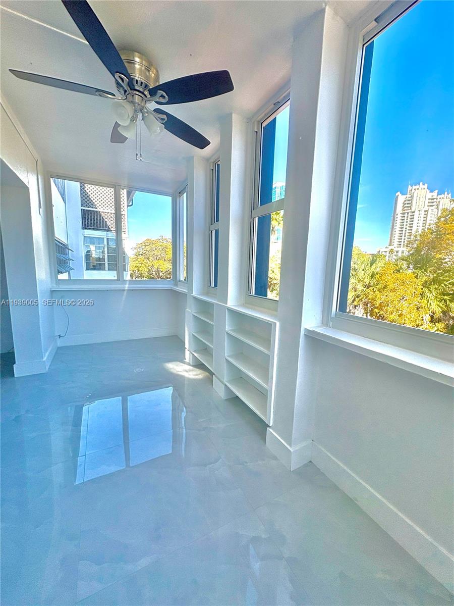9159 Southwest 77th Avenue, Unit 314 Miami, FL 33156 - Photo 11 of 53 a view of an empty room with a window and wooden floor