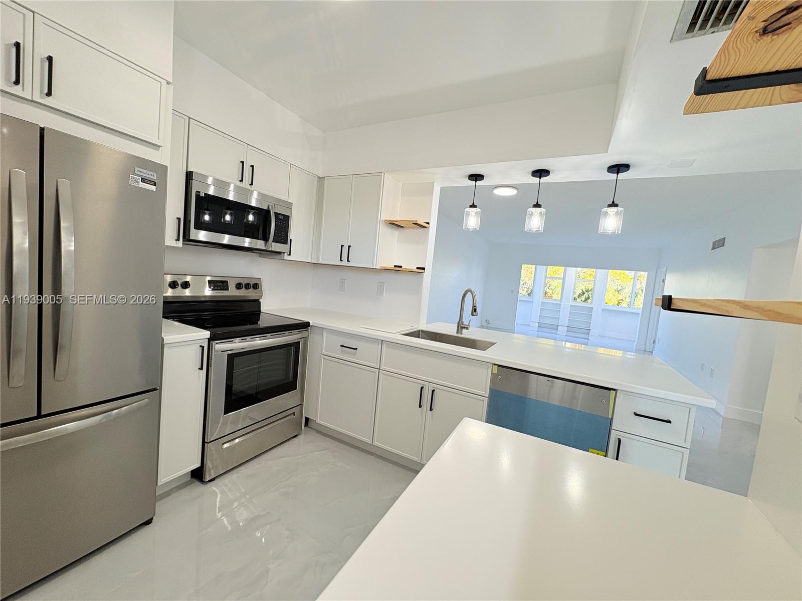 9159 Southwest 77th Avenue, Unit 314 Miami, FL 33156 - Photo 14 of 53 a kitchen with granite countertop stainless steel appliances and refrigerator
