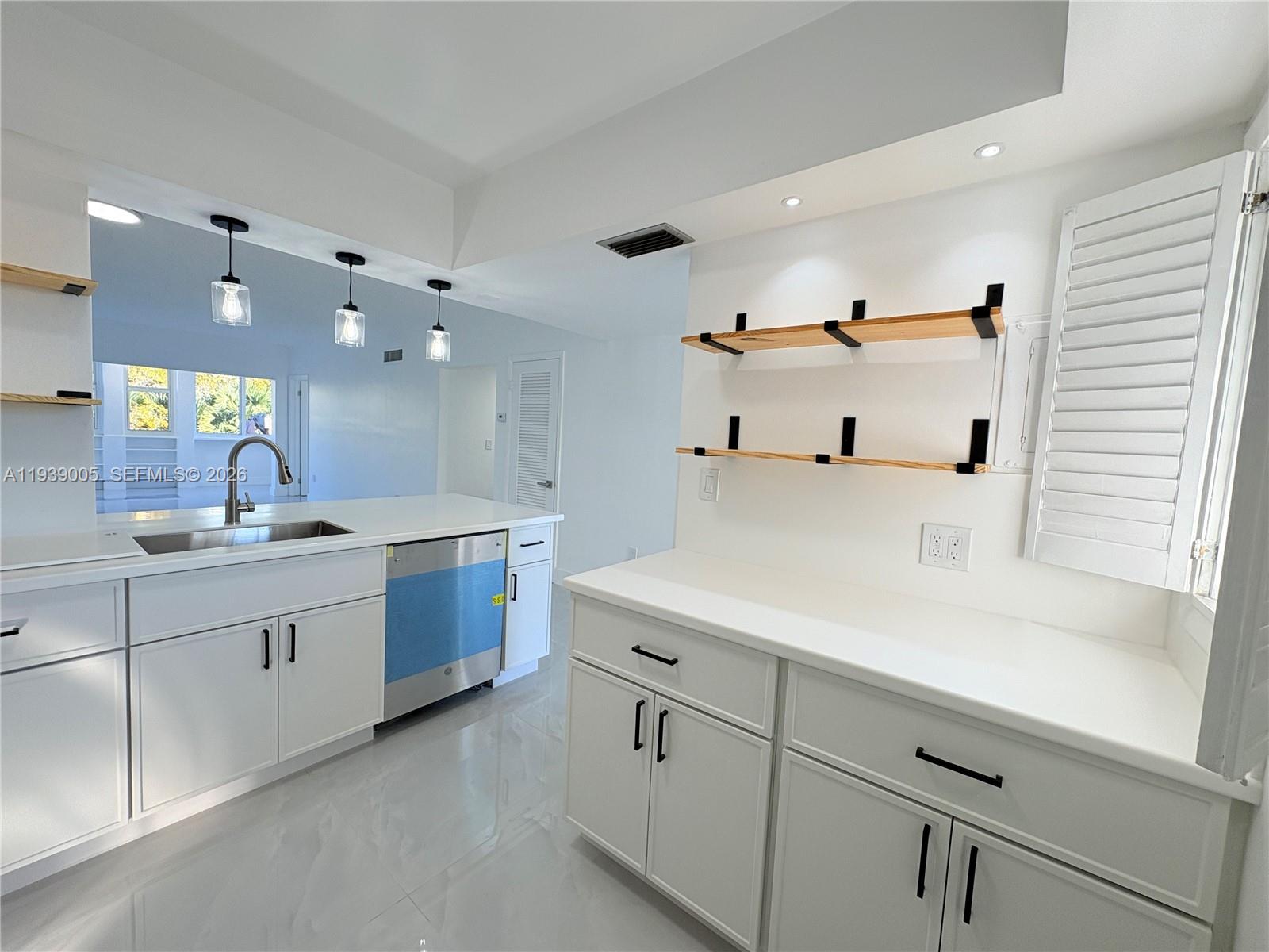 9159 Southwest 77th Avenue, Unit 314 Miami, FL 33156 - Photo 18 of 53 a kitchen with cabinets and sink