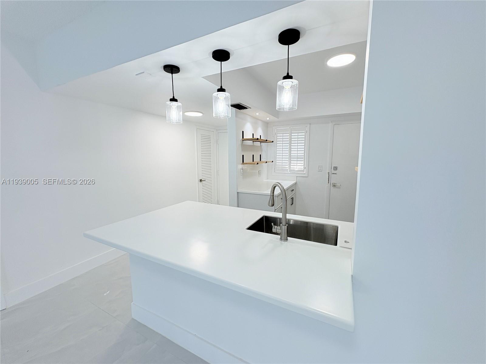 9159 Southwest 77th Avenue, Unit 314 Miami, FL 33156 - Photo 21 of 53 a bathroom with a sink a toilet and a mirror