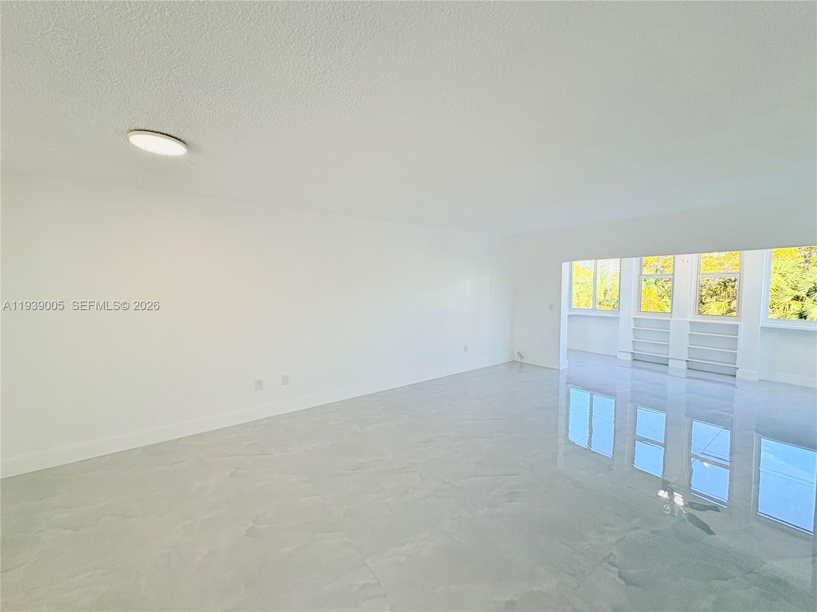9159 Southwest 77th Avenue, Unit 314 Miami, FL 33156 - Photo 24 of 53 an empty room with windows