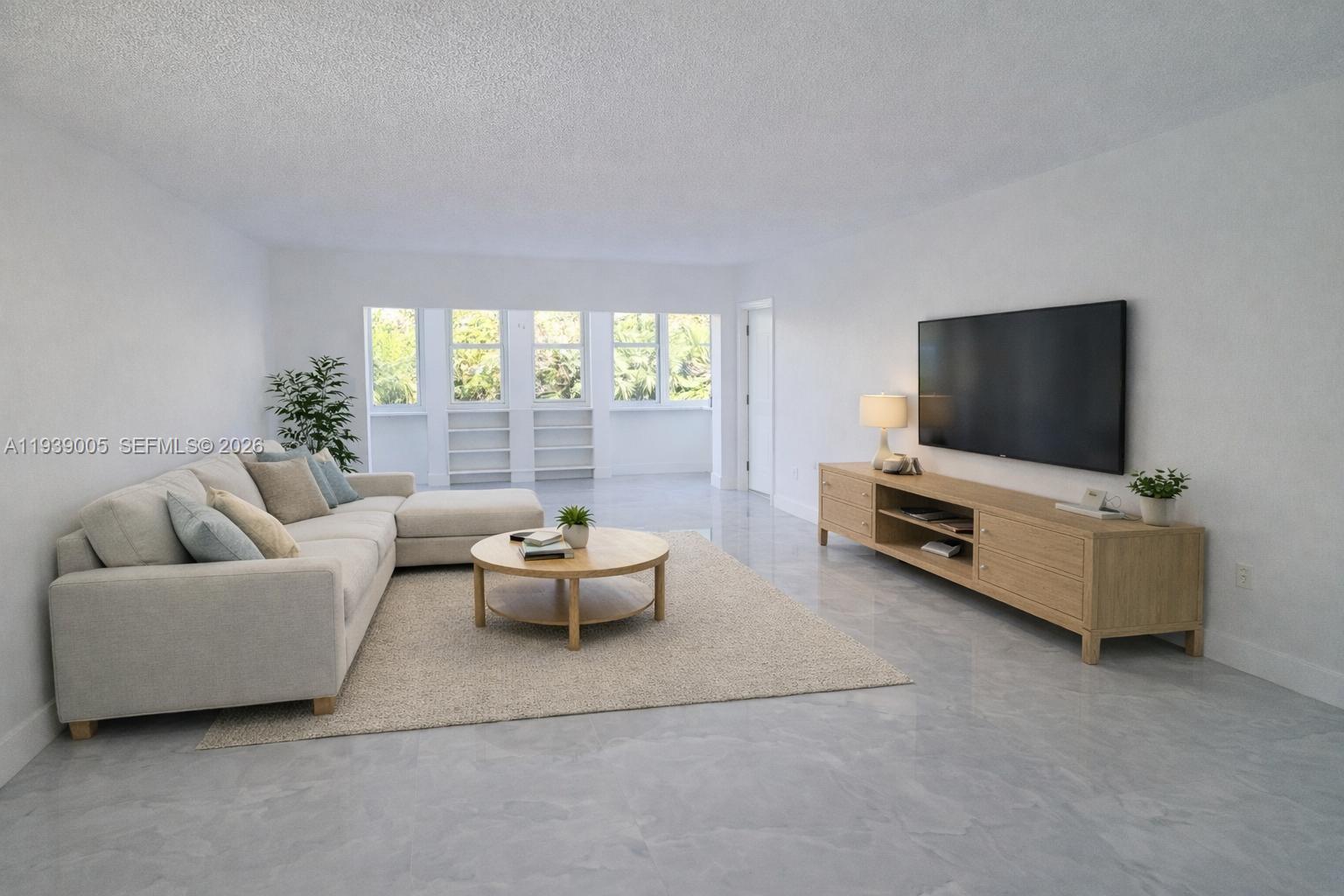 9159 Southwest 77th Avenue, Unit 314 Miami, FL 33156 - Photo 3 of 53 a living room with furniture and a flat screen tv
