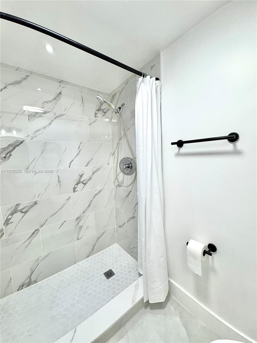9159 Southwest 77th Avenue, Unit 314 Miami, FL 33156 - Photo 45 of 53 a bathroom with a shower and a tub