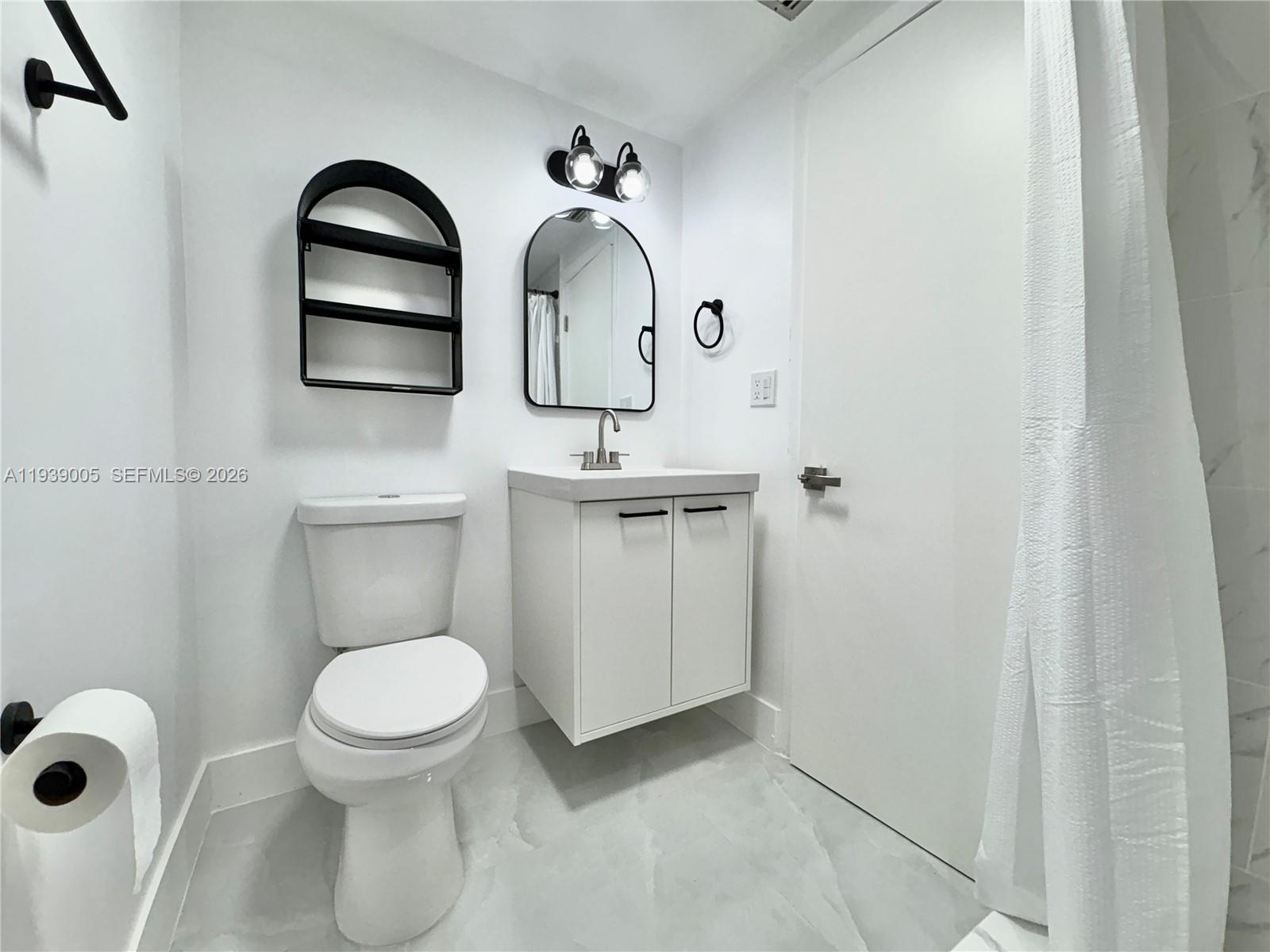 9159 Southwest 77th Avenue, Unit 314 Miami, FL 33156 - Photo 47 of 53 a bathroom with a toilet sink and mirror