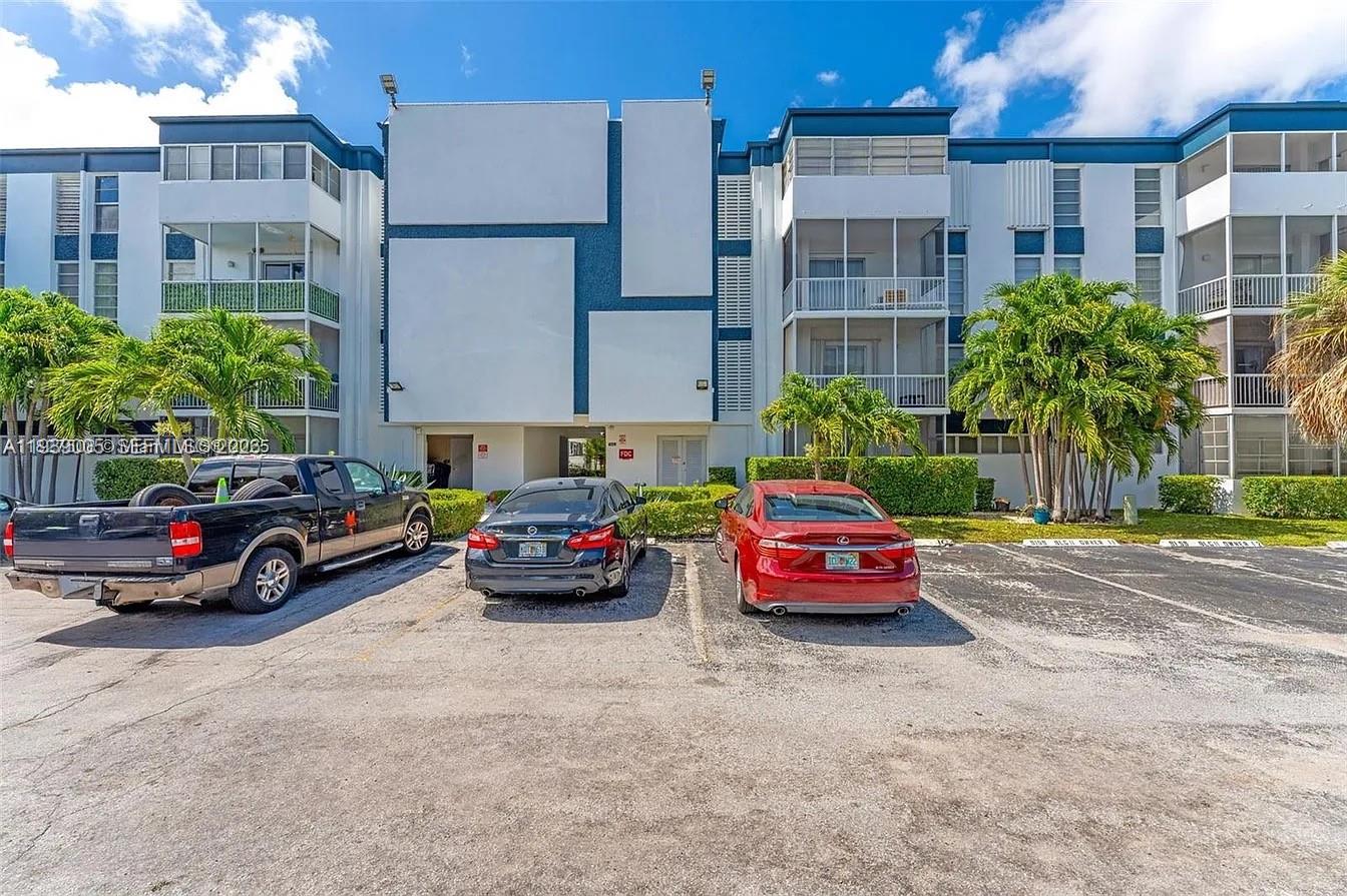 9159 Southwest 77th Avenue, Unit 314 Miami, FL 33156 - Photo 52 of 53 a car parked in front of a building
