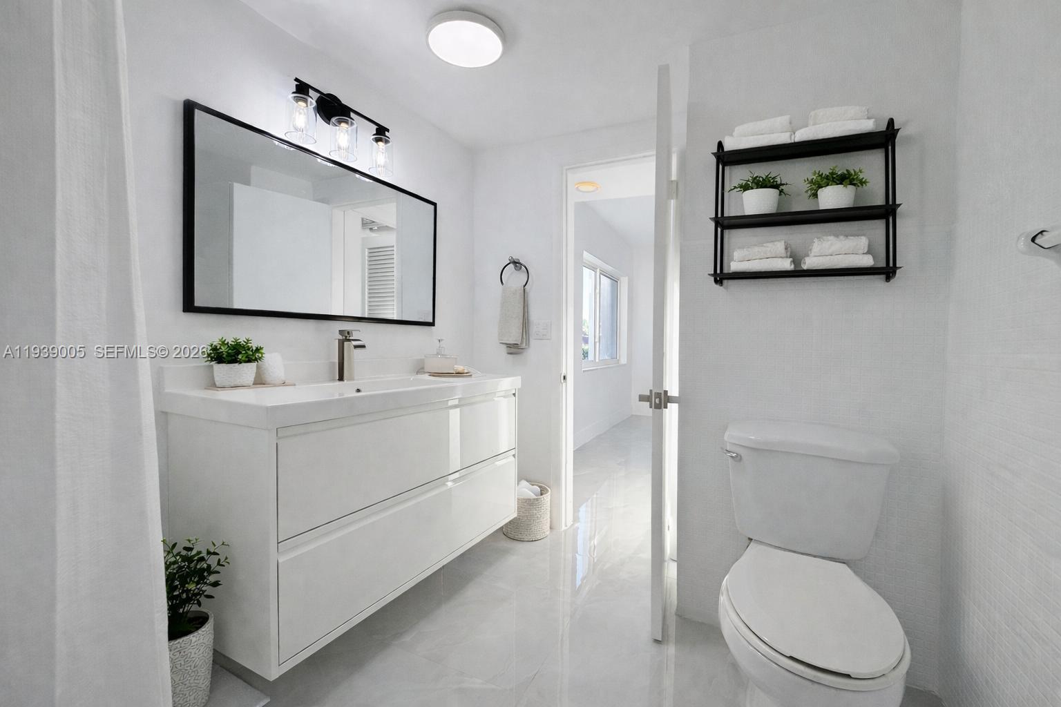 9159 Southwest 77th Avenue, Unit 314 Miami, FL 33156 - Photo 7 of 53 a bathroom with a toilet sink vanity tub and mirror