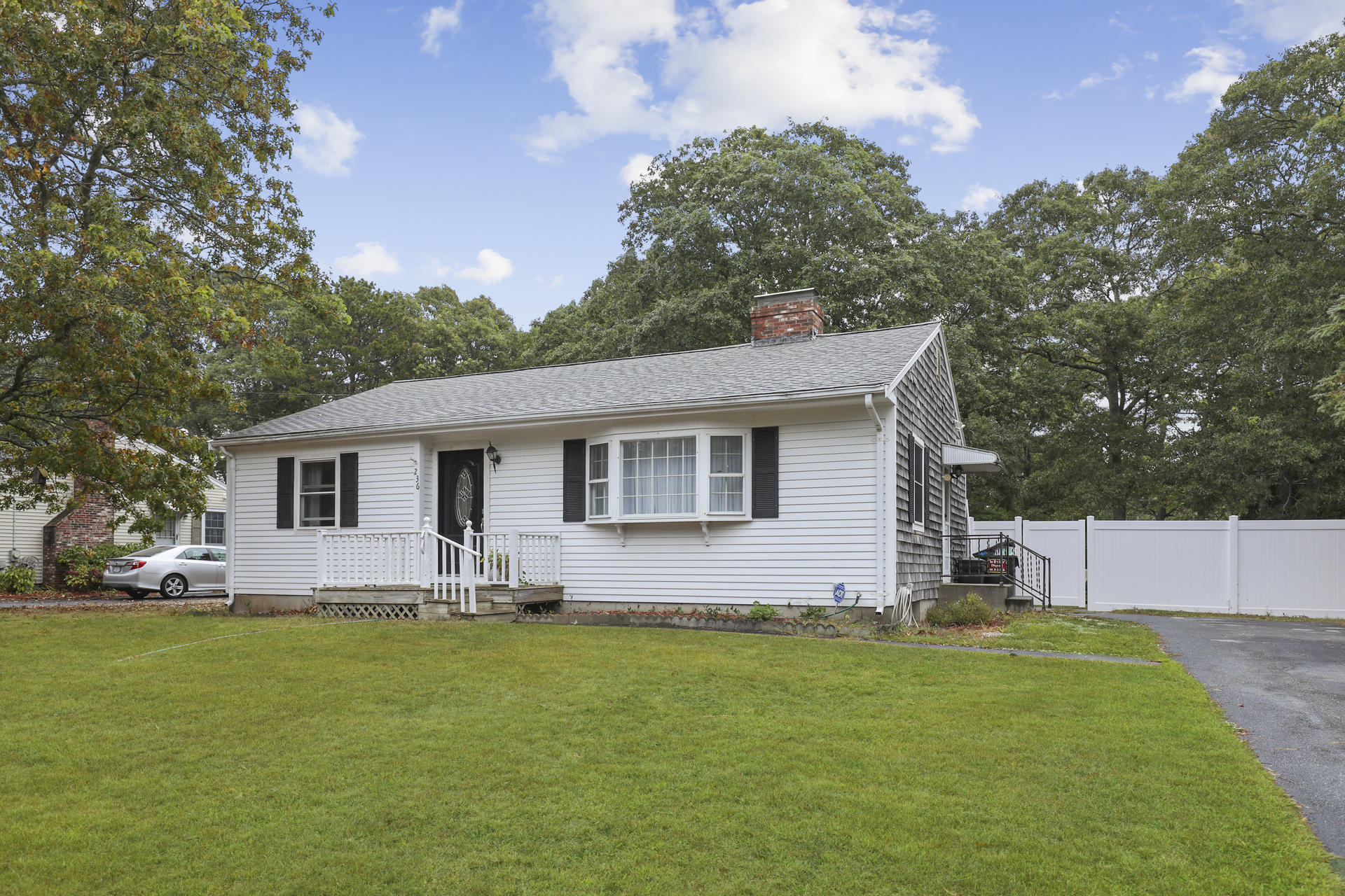 236 Megan Road Hyannis, MA 02601 - Photo 1 of 20 a front view of house with yard and trees in the background