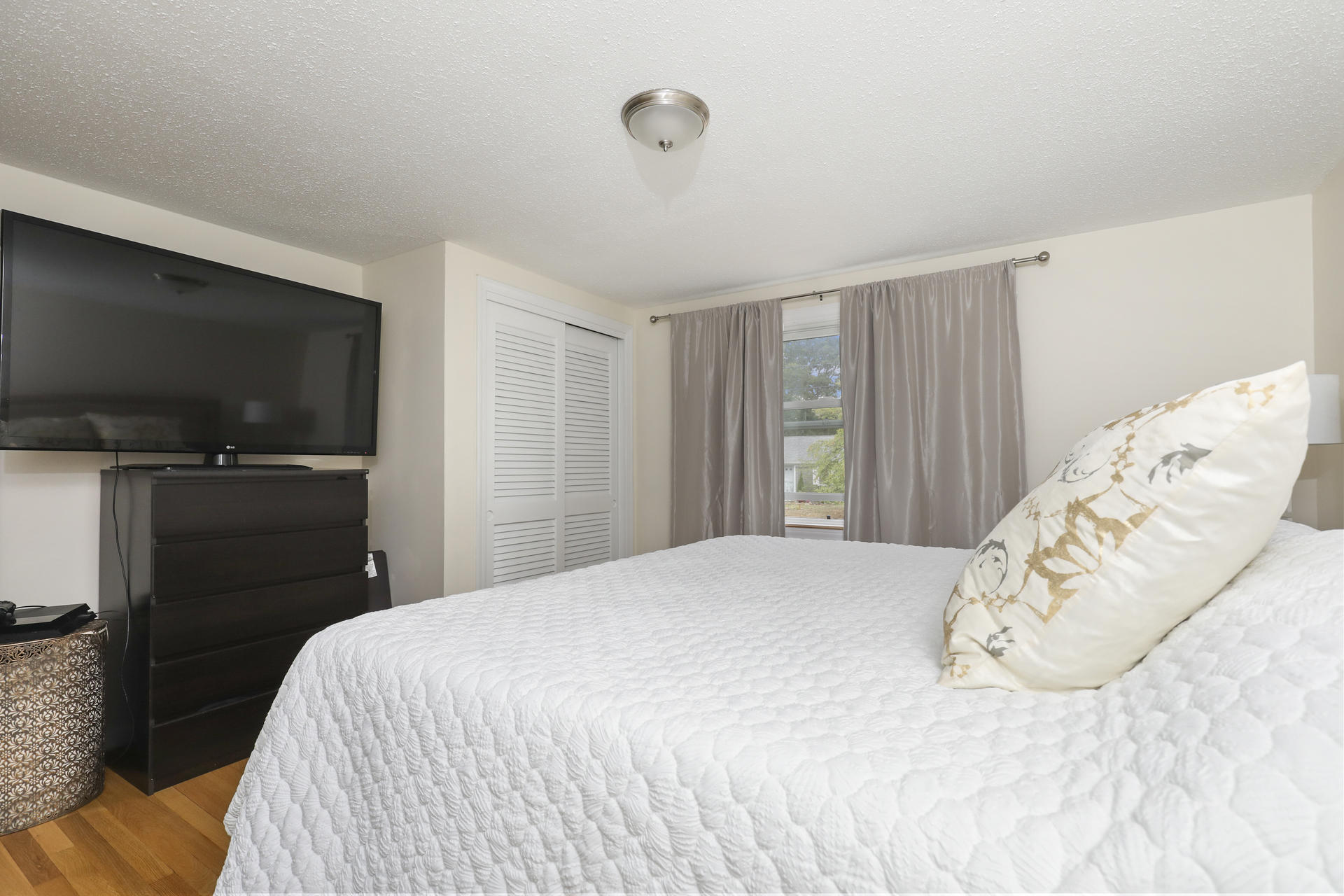236 Megan Road Hyannis, MA 02601 - Photo 11 of 20 a bedroom with a bed and a flat screen tv