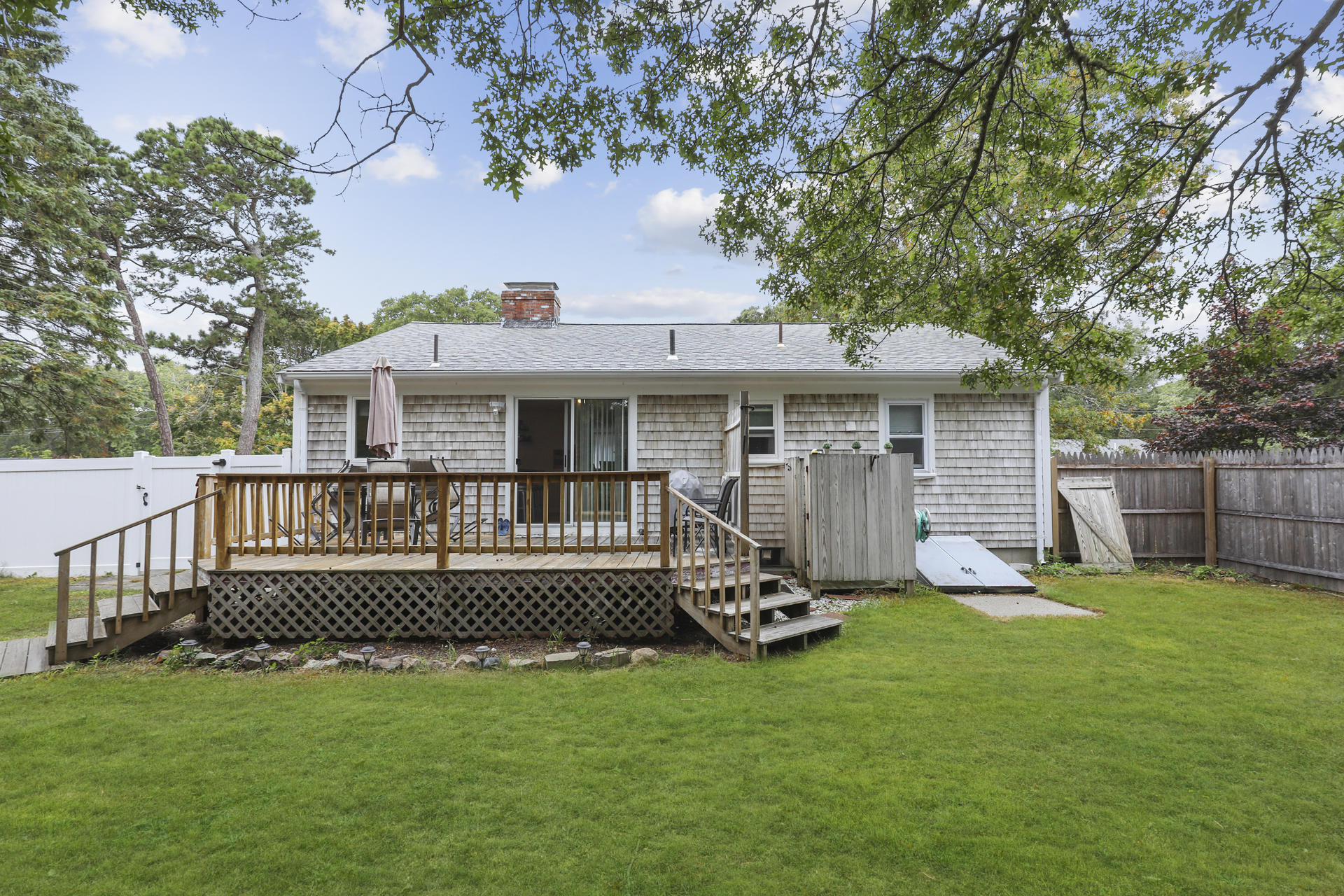 236 Megan Road Hyannis, MA 02601 - Photo 18 of 20 a front view of a house with a garden and deck