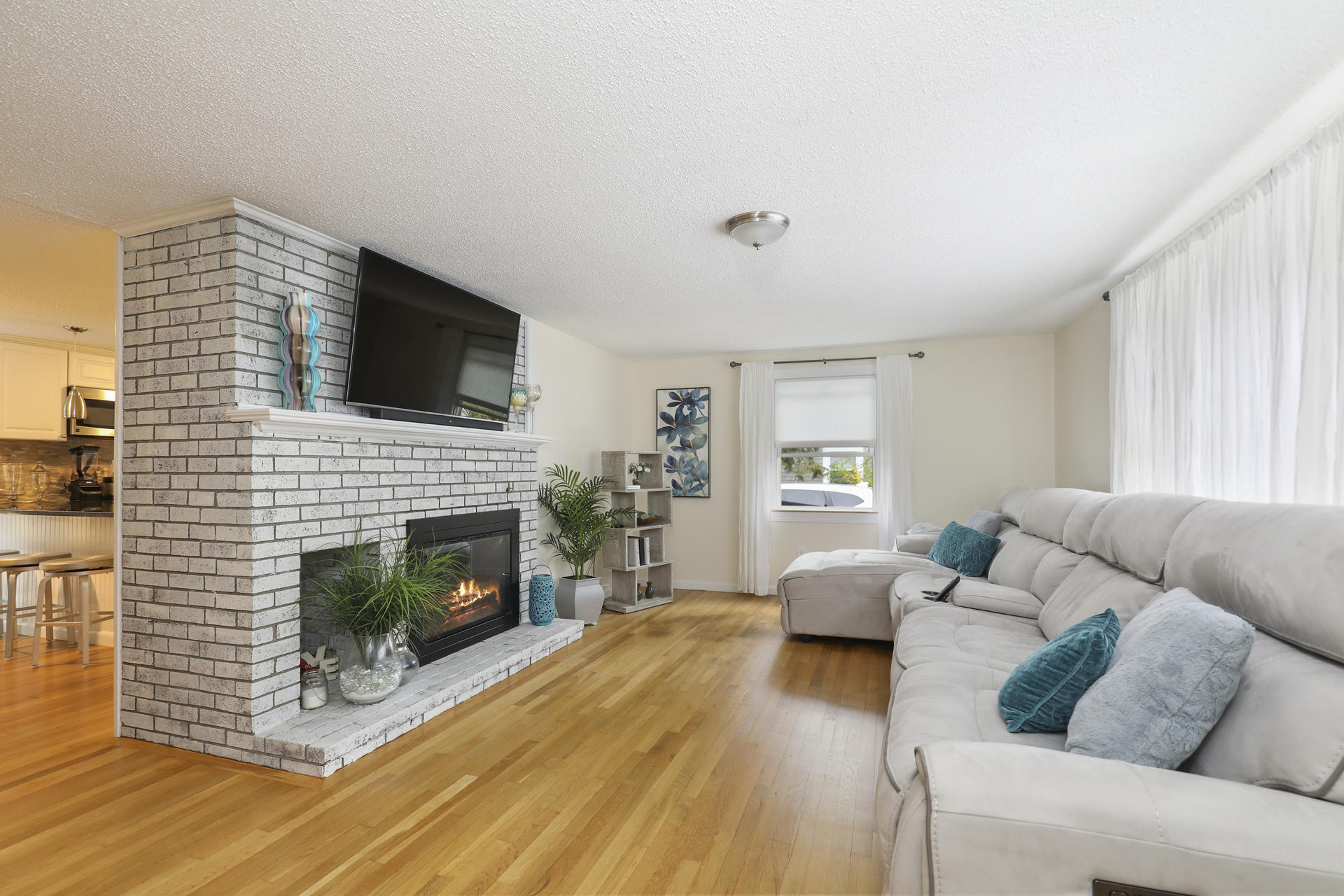 236 Megan Road Hyannis, MA 02601 - Photo 3 of 20 a living room with furniture a flat screen tv and a fireplace