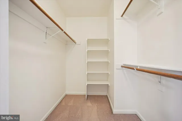 a bathroom with a granite countertop sink a toilet and a mirror