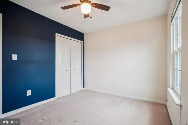 a bathroom with a granite countertop sink a toilet and a mirror