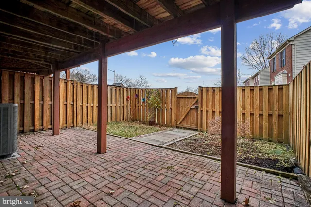 a view of a house with a yard and potted plants
