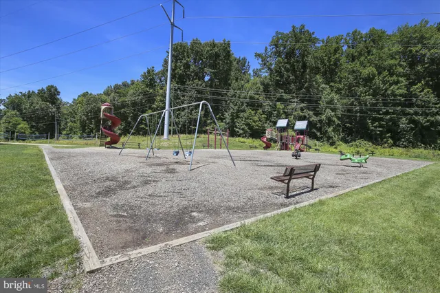 a patio with a table and chairs under an umbrella