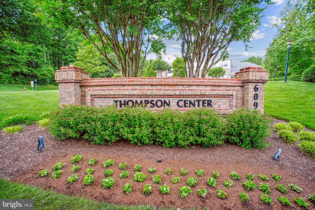 a view of a cars park in front of a building