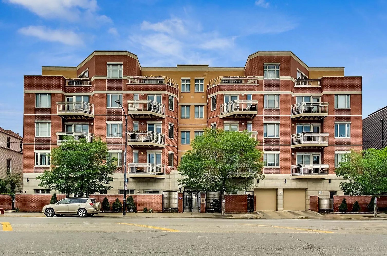 4950 North Western Avenue, Unit 2J Chicago, IL 60625 - Photo 1 of 1 a front view of a residential apartment building with a yard