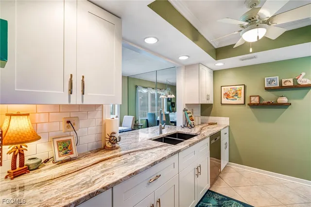 a kitchen with stainless steel appliances kitchen island granite countertop a sink and cabinets