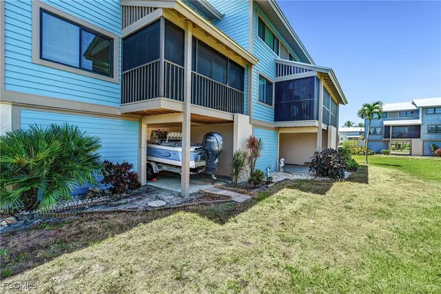 a view of a house with backyard porch and sitting area