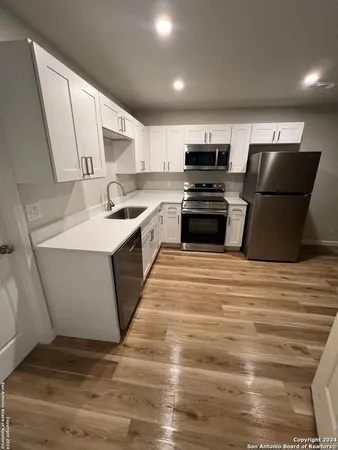 a kitchen with stainless steel appliances kitchen island granite countertop a stove top oven a sink and dishwasher