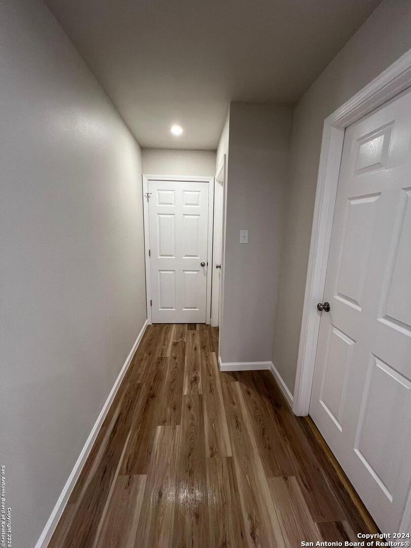 1912 14th Street, Unit 8 Hondo, TX 78861 - Photo 5 of 7 a view of a hallway with wooden floor