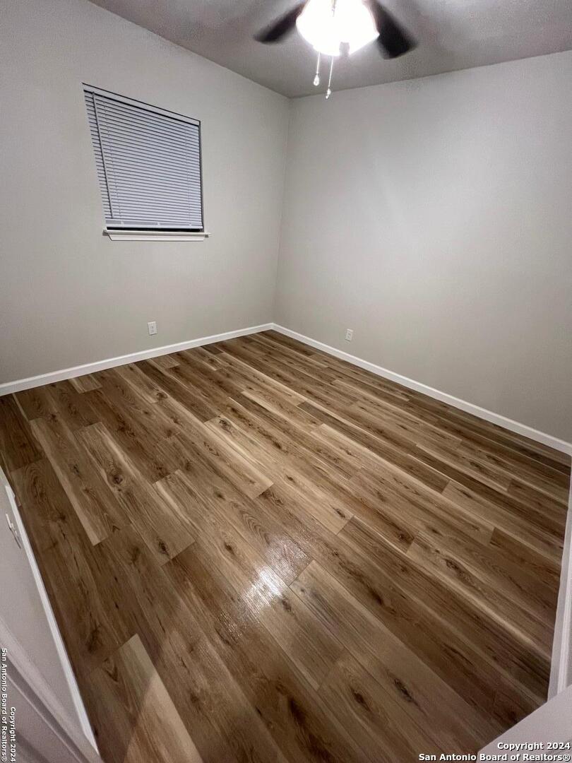 1912 14th Street, Unit 8 Hondo, TX 78861 - Photo 7 of 7 a view of a room with a ceiling fan and wooden floor