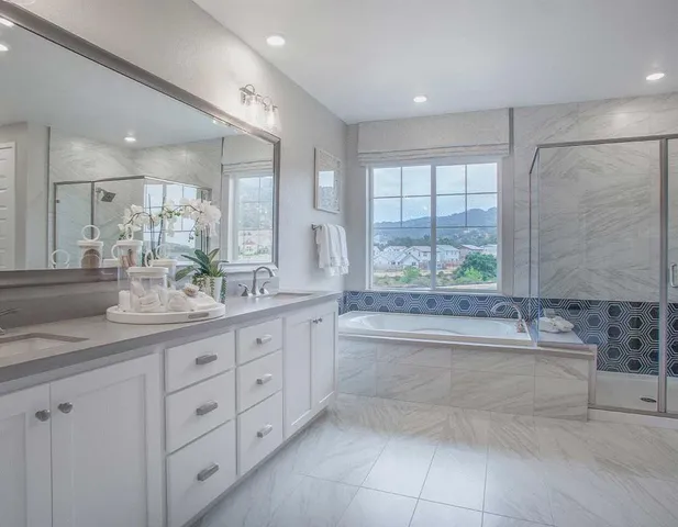 a bathroom with a large tub sink and double vanity